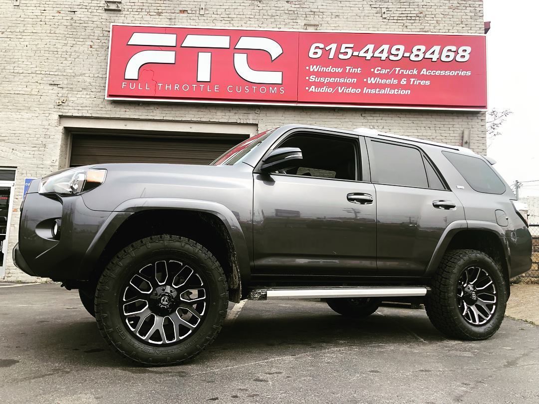 Gray SUV parked outside a building with a red FTC sign