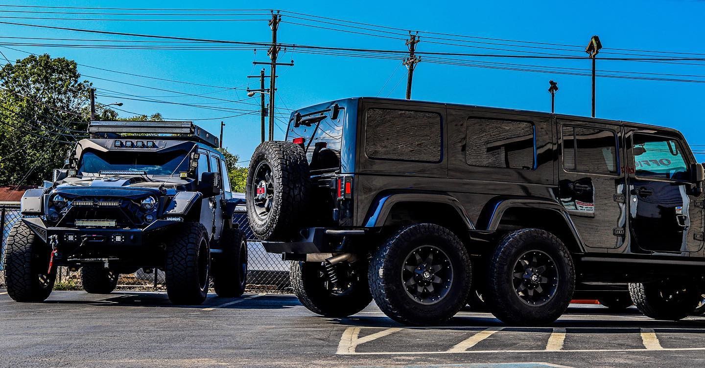 Two rugged off-road vehicles parked side by side in a sunny parking lot