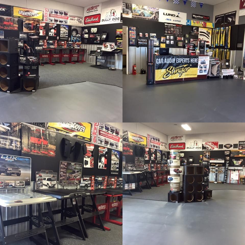 Auto parts store interior with shelves, signs, and displays in a spacious showroom.