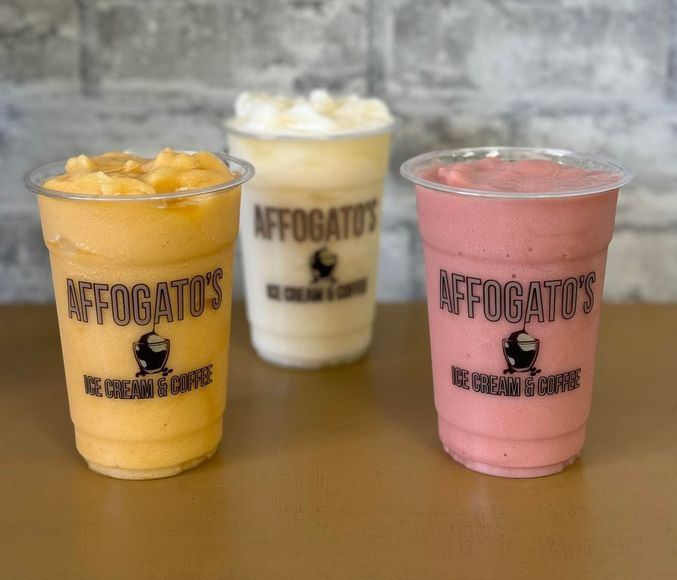Three cups of affogato 's smoothies are sitting on a table.