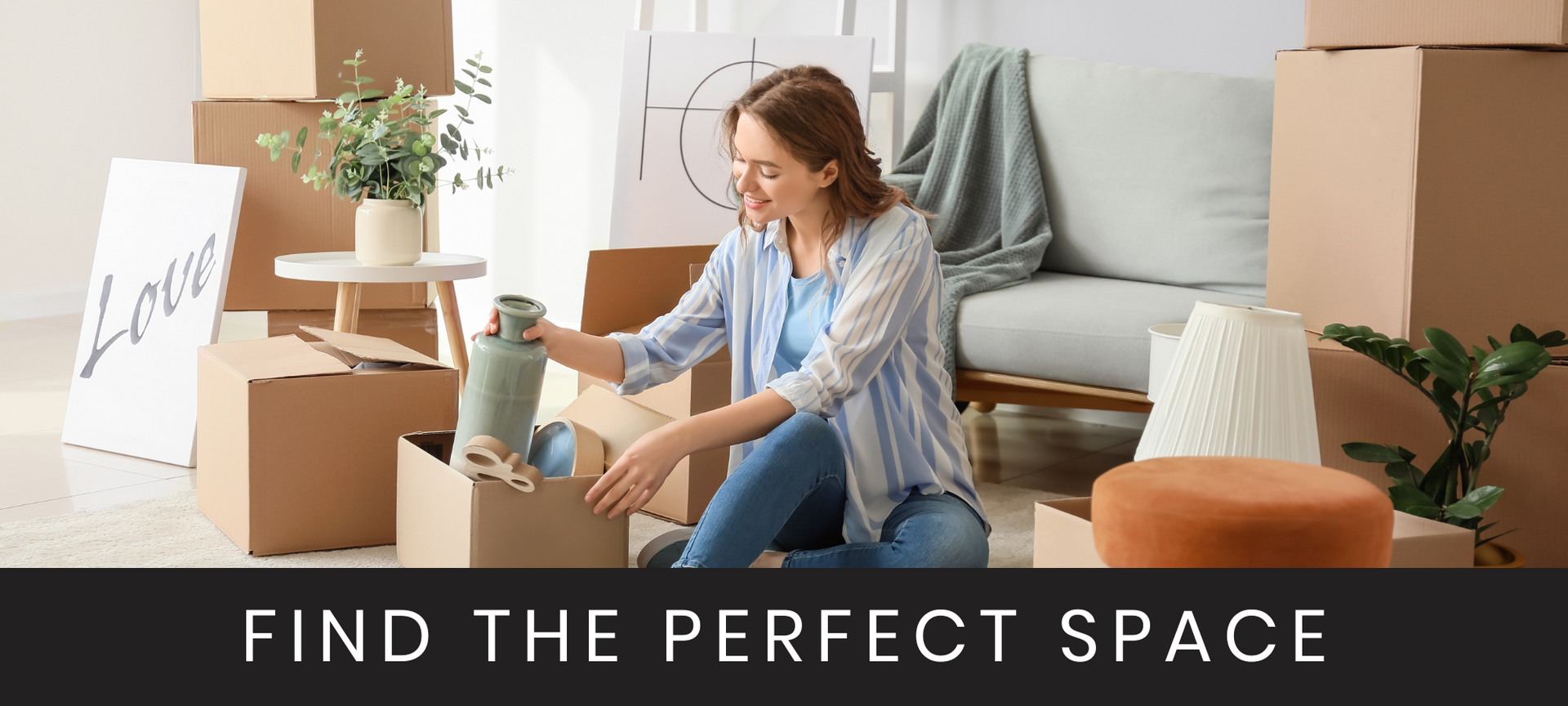 Woman packing boxes in a bright living room with