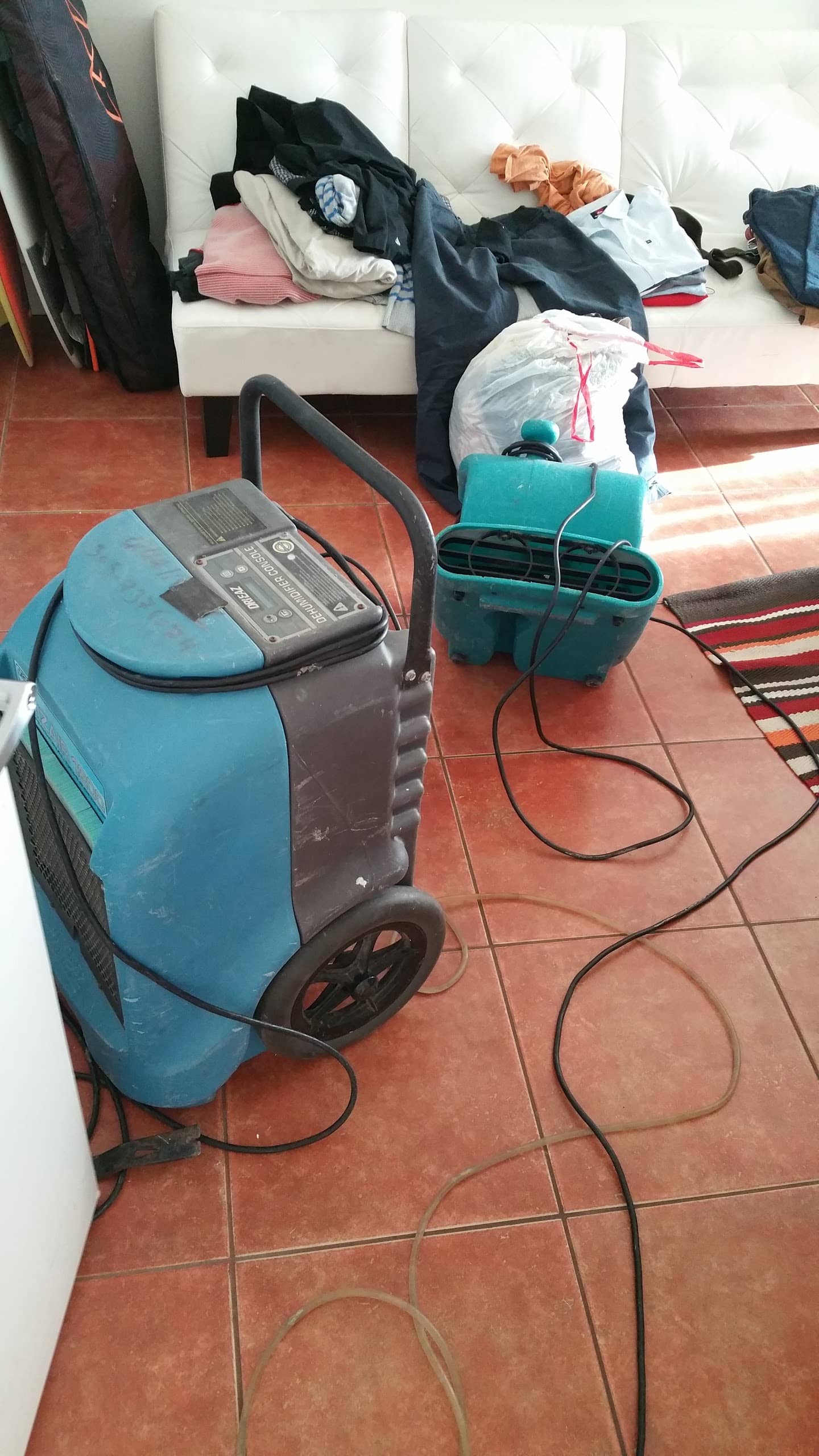 a closeup photo of a commercial dehumidifier and blow air fan in a south florida water restoration job