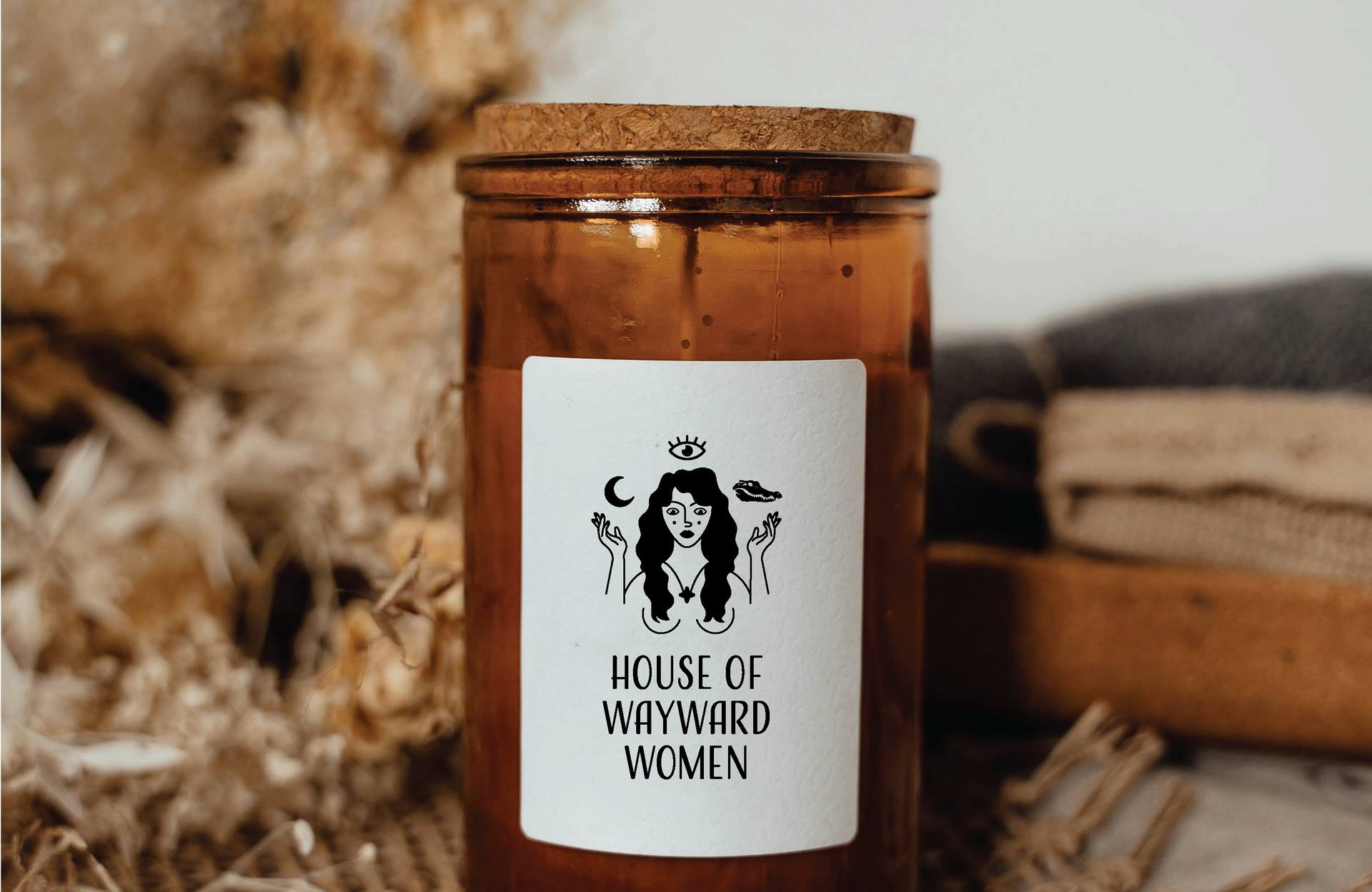 Candle in amber glass jar with label
