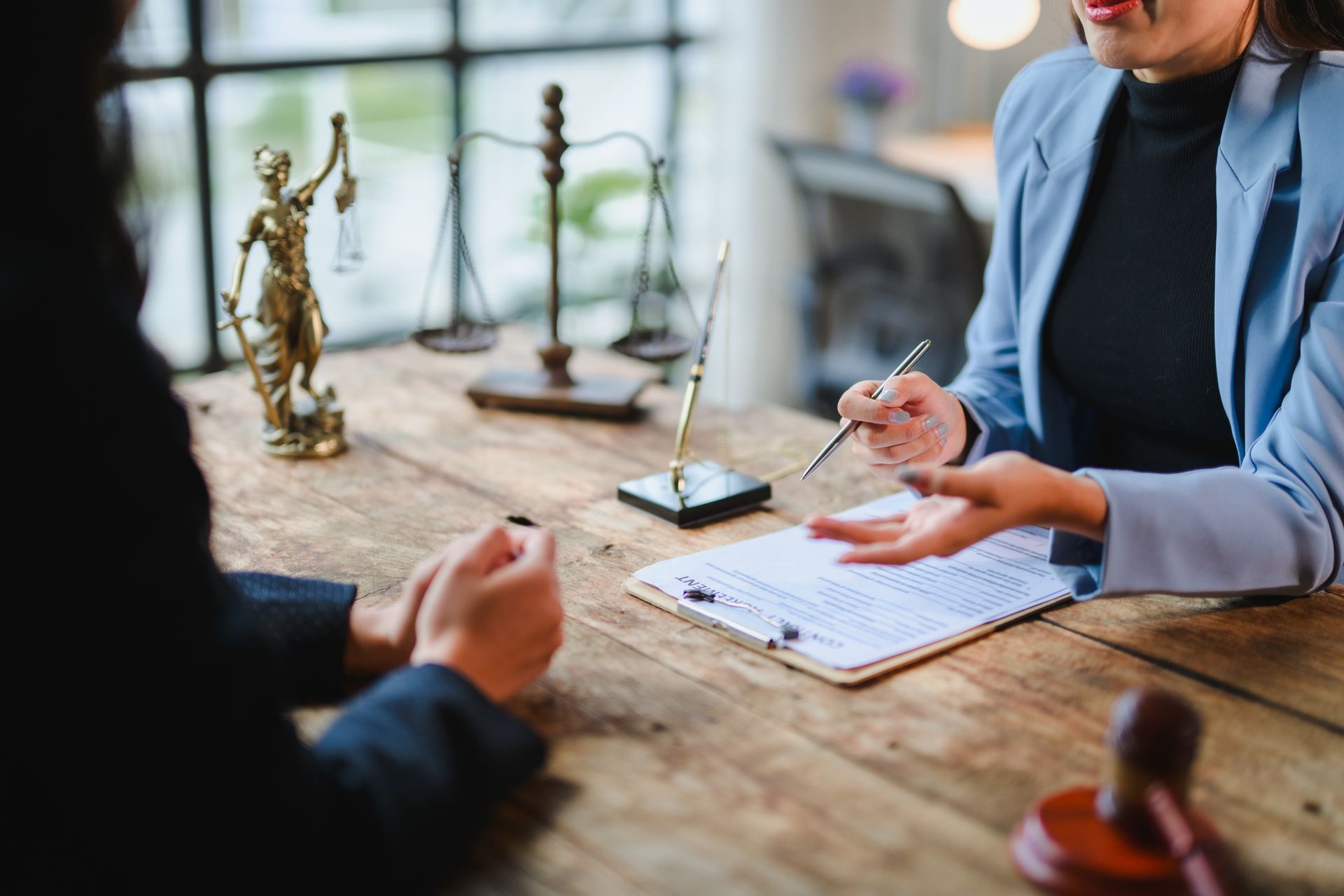 Lawyer explaining contract details to client during meeting in office — Albuquerque, NM — Duhigg, Cronin, Spring & Berlin