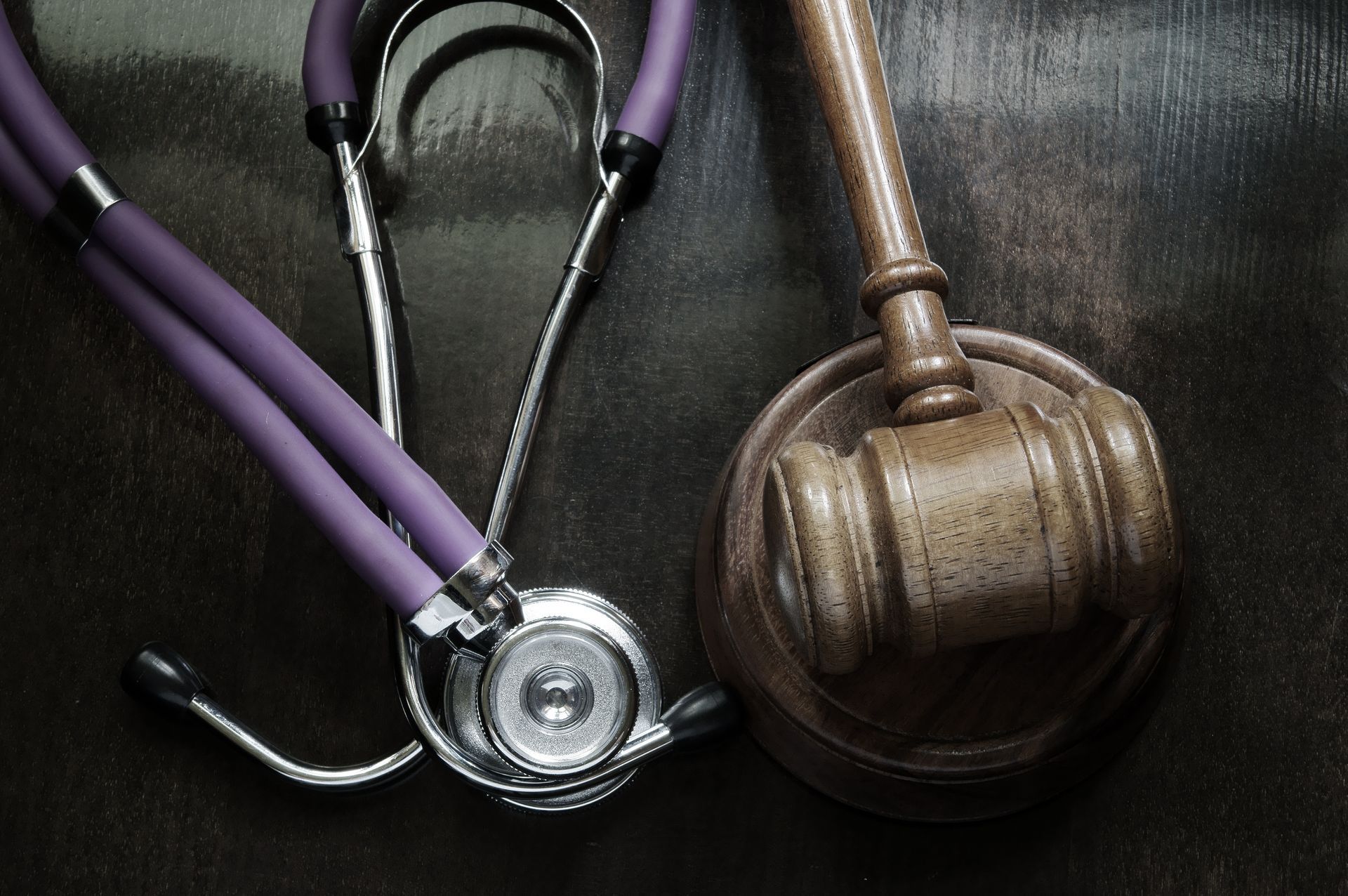 Judge gavel and stethoscope close-up, malpractice concept Judge gavel and stethoscope close-up, malpractice concept