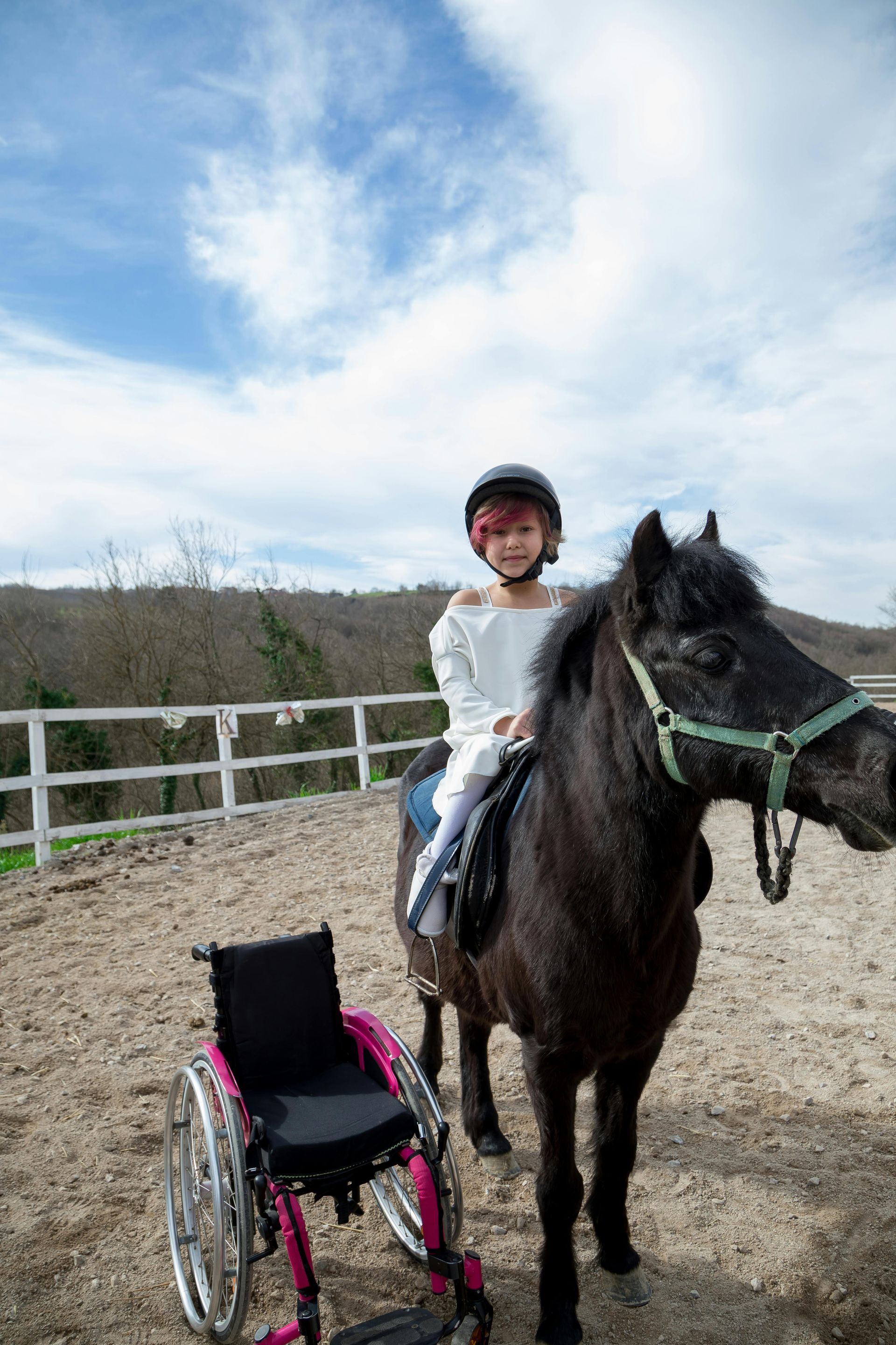 Wheelchair assisted student on horse