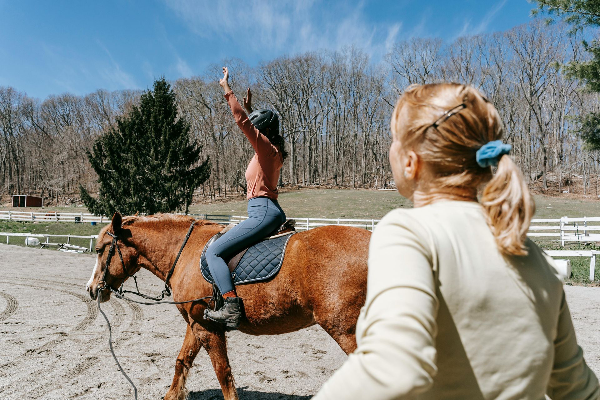 Student on horse riding with instructor