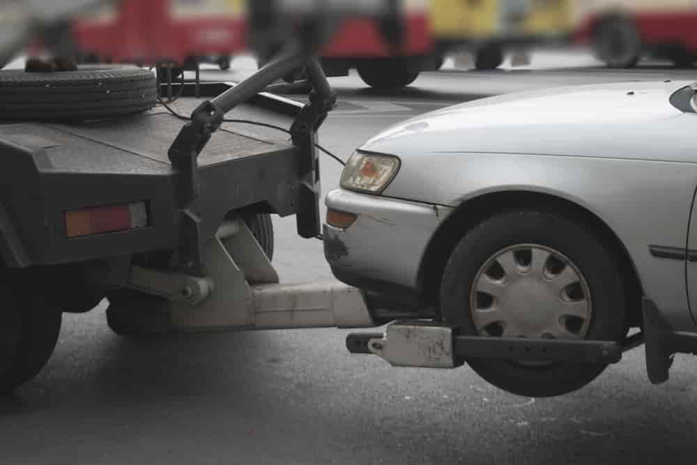 A Car Is Being Towed By A Tow Truck — Twin City Auto Dismantlers In Wagga Wagga, NSW