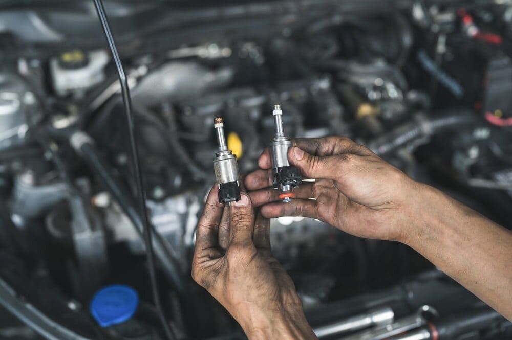 A Close Up Of A Person Holding A Pair Of Fuel Injector — Twin City Auto Dismantlers In Wangaratta, NSW