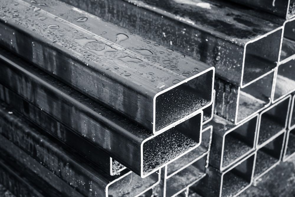A Black And White Photo Of A Stack Of Metal Pipes — Tenterfield Timber & Hardware in Tenterfield, NSW