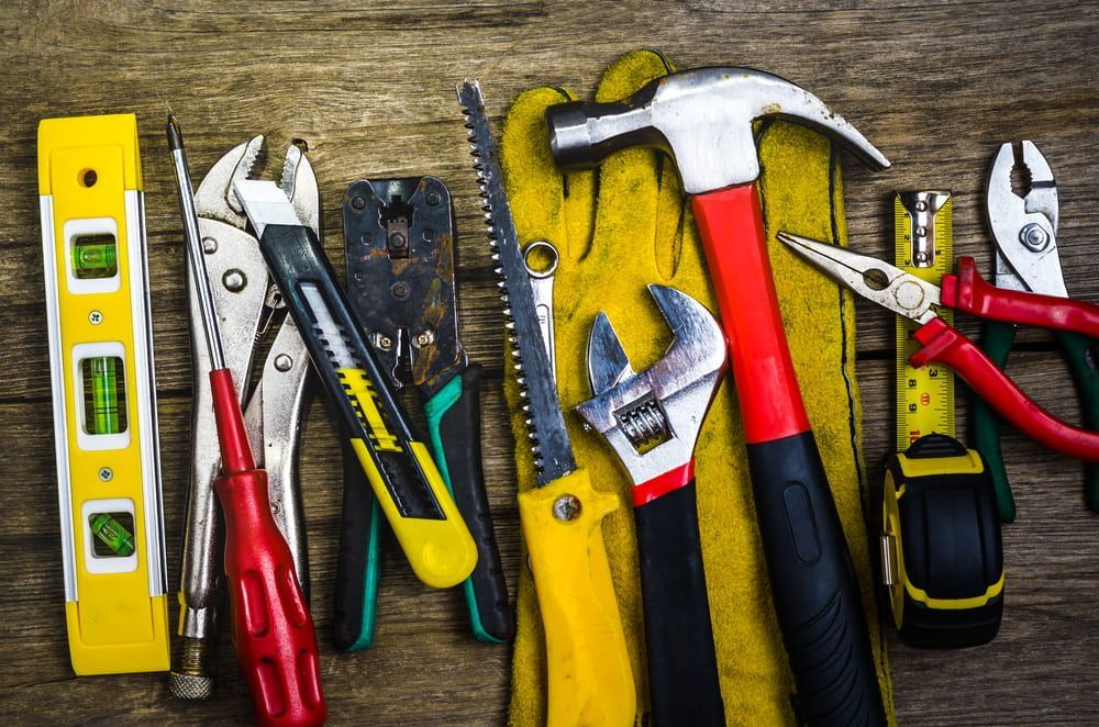 A Bunch Of Tools Are Sitting On A Wooden Table — Tenterfield Timber & Hardware in Tenterfield, NSW