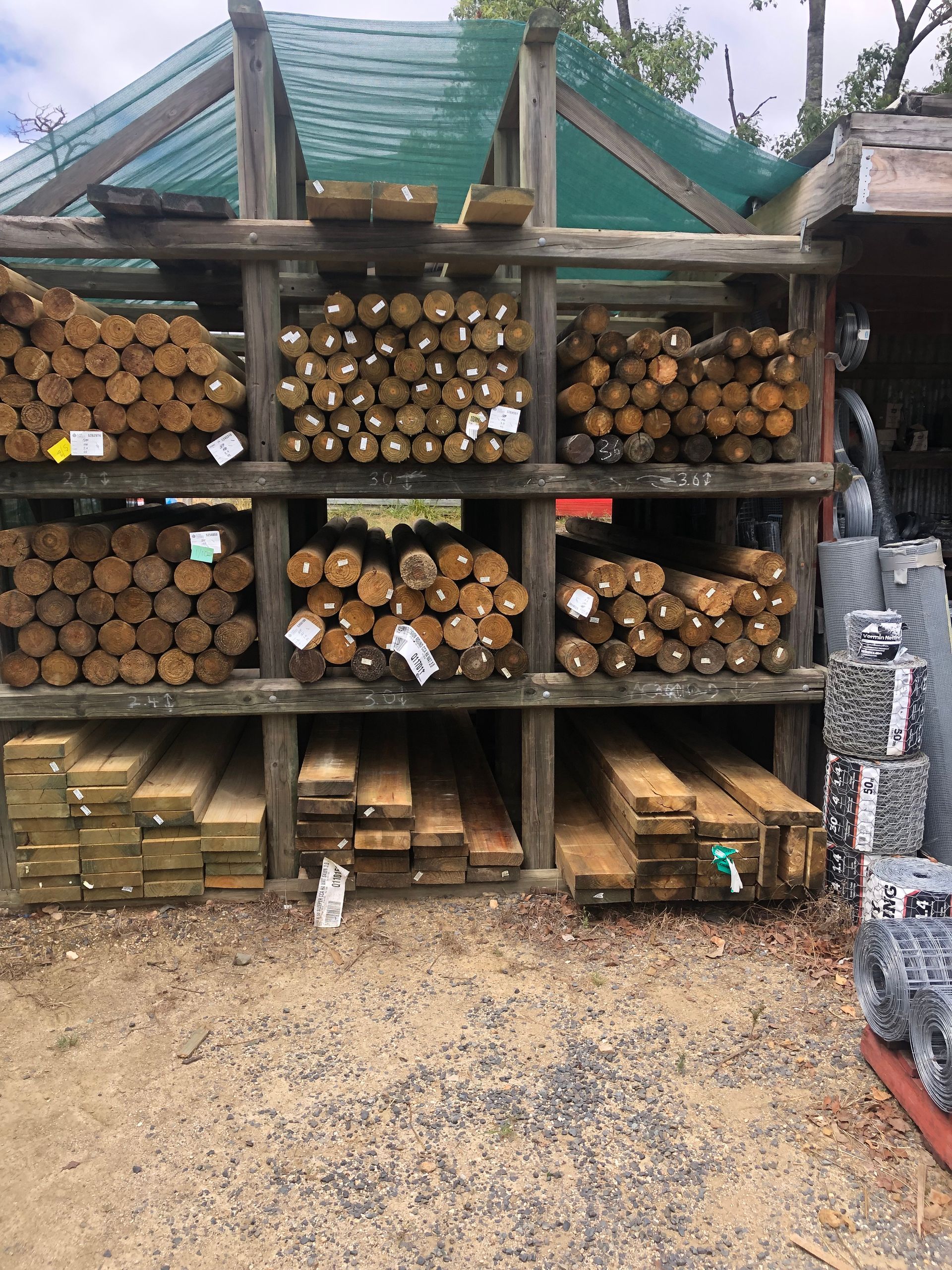 A Pile Of Wooden Beams Stacked On Top Of Each Other — Tenterfield Timber & Hardware in Tenterfield, NSW