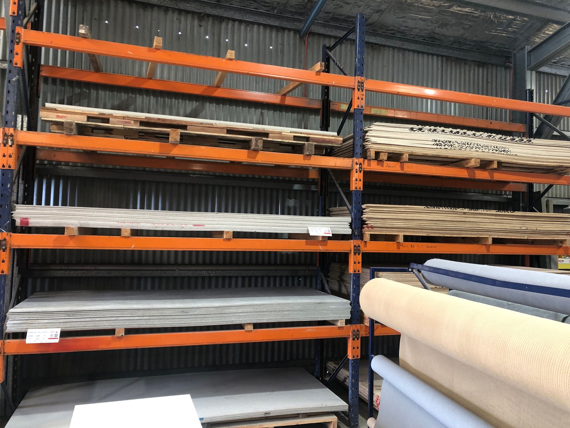 A Bunch Of Wooden Boards Are Stacked On Top Of Each Other In A Warehouse — Tenterfield Timber & Hardware in Tenterfield, NSW