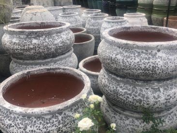 A bunch of pots are stacked on top of each other.
