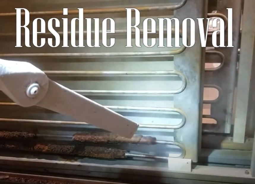 White tool removing dark residue from metal pipes. Text reads