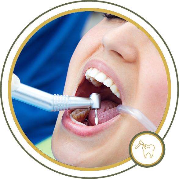 Person at dentist, mouth open, receiving dental work with drill and suction.
