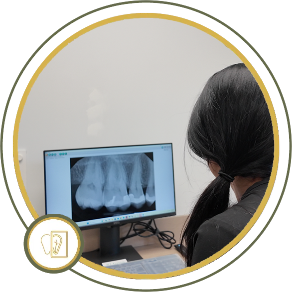 Person looking at dental X-ray on a computer monitor in a dental office.