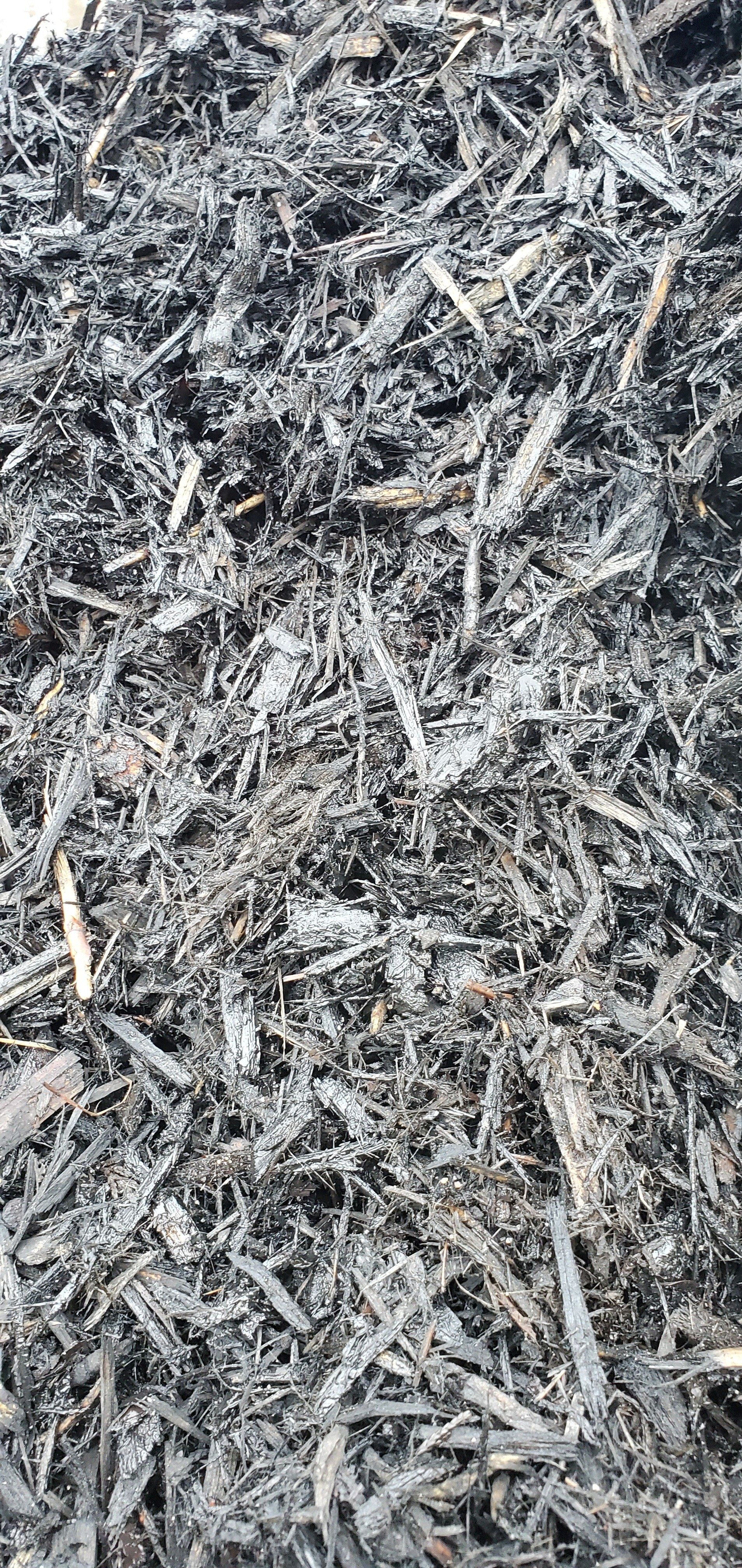 Pile of gray and black wood chips.
