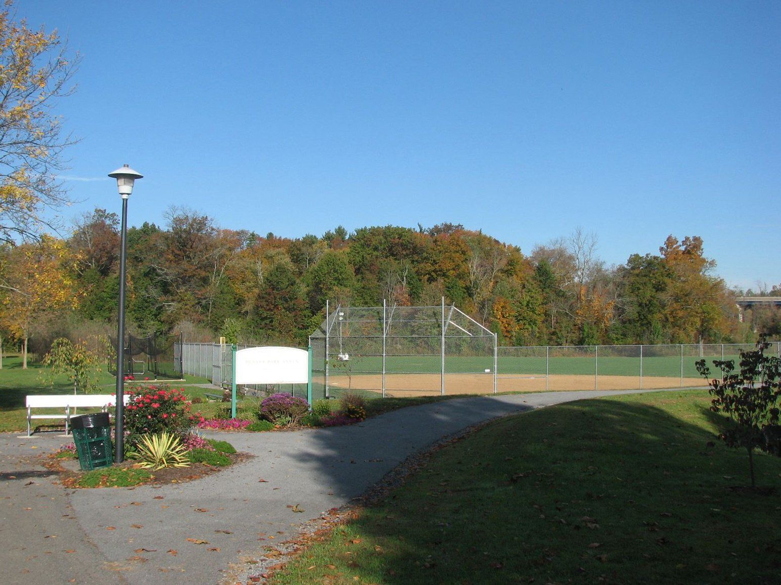 A path leading to a baseball field in a park