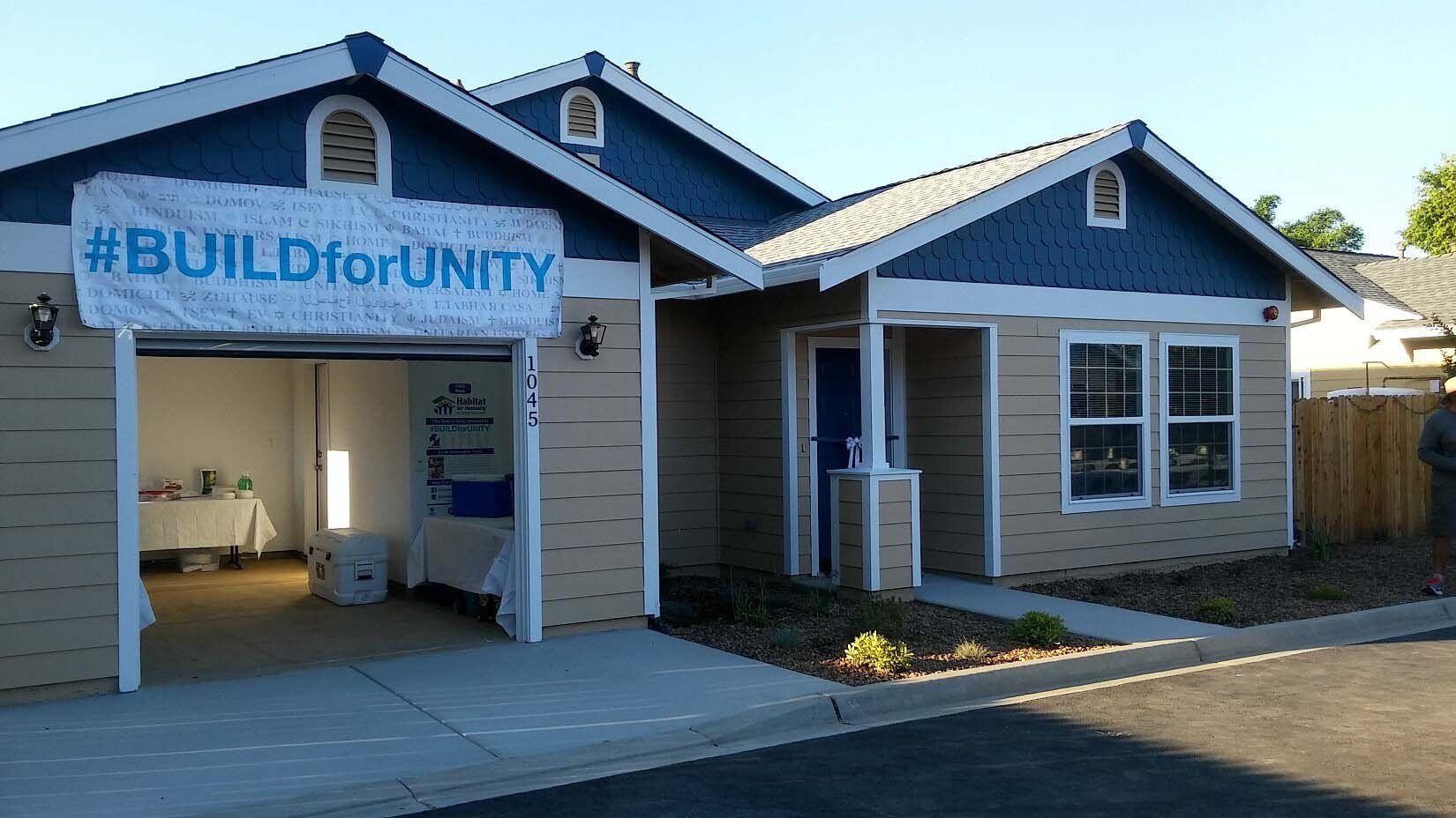 A house with a sign that says #buildforunity