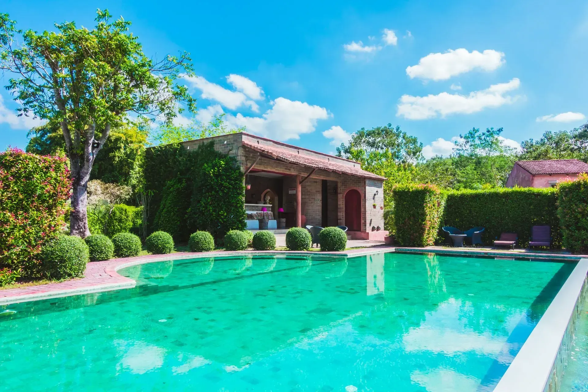 A house with a swimming pool in front of it