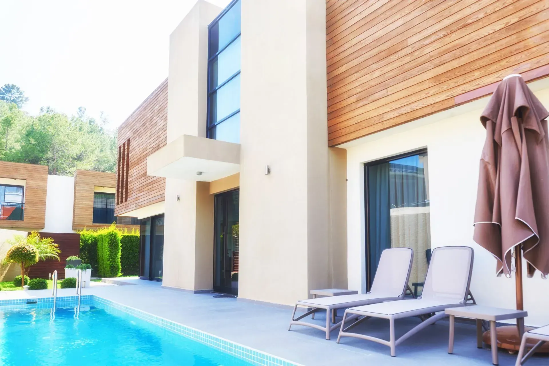 A large white house with a swimming pool in front of it