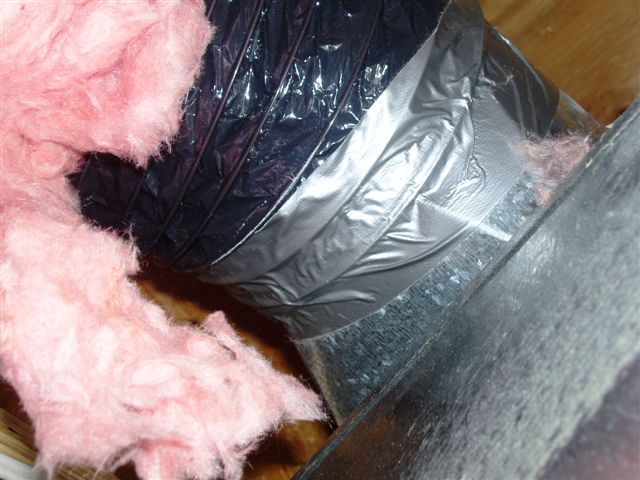 A duct with pink insulation and duct tape on it