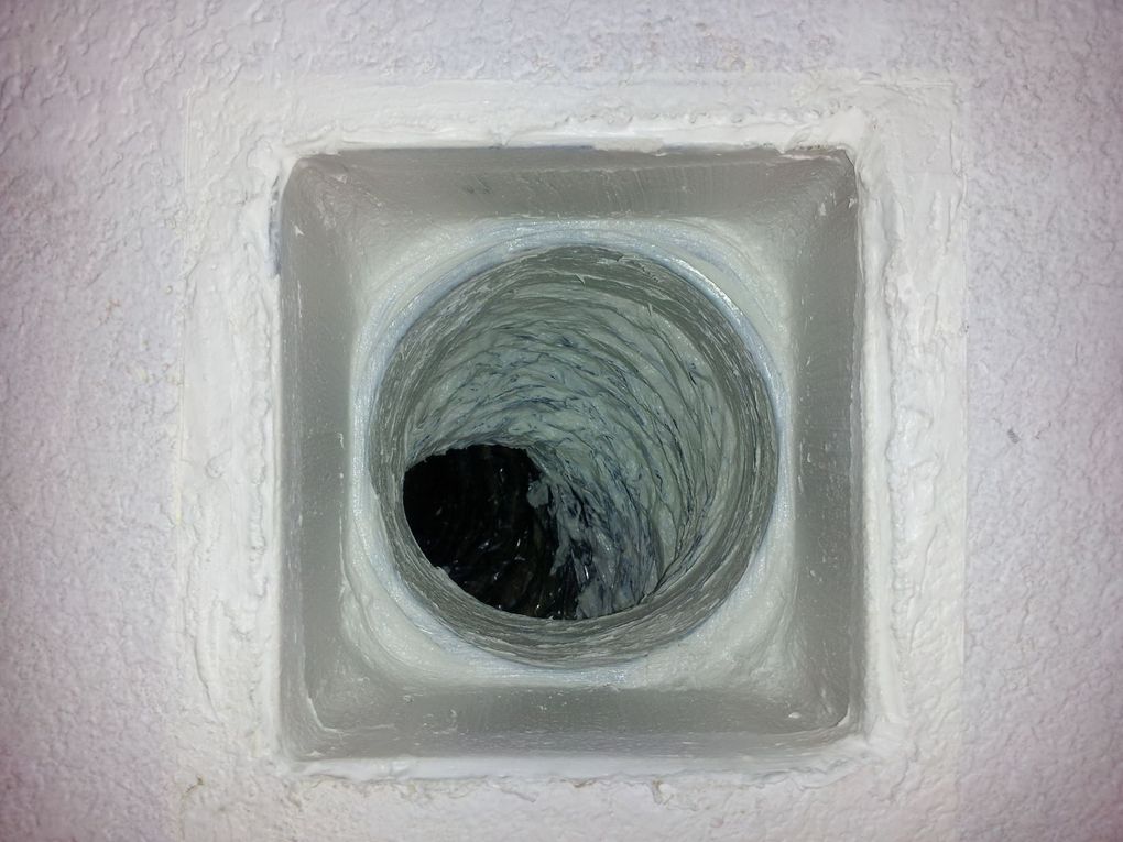 A close up of a hole in a wall with a hole in the middle.