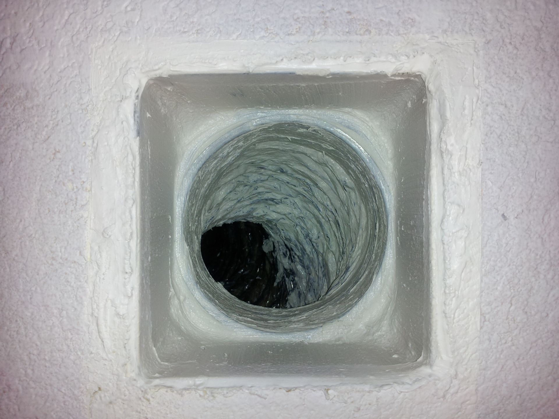A close up of a hole in a wall with a hole in the middle.