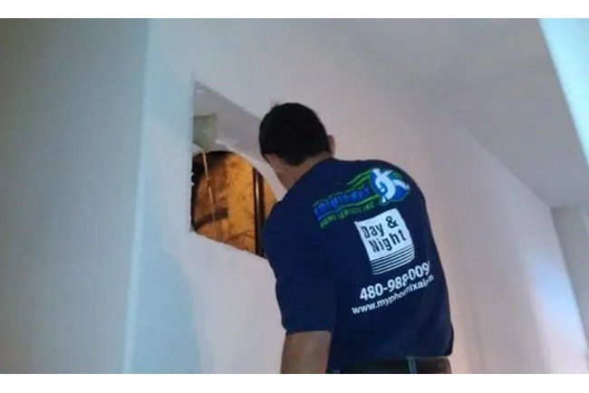 A man wearing a blue shirt that says bay & night