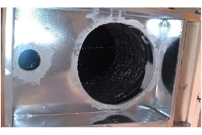 A metal box with a hole in the middle of it
