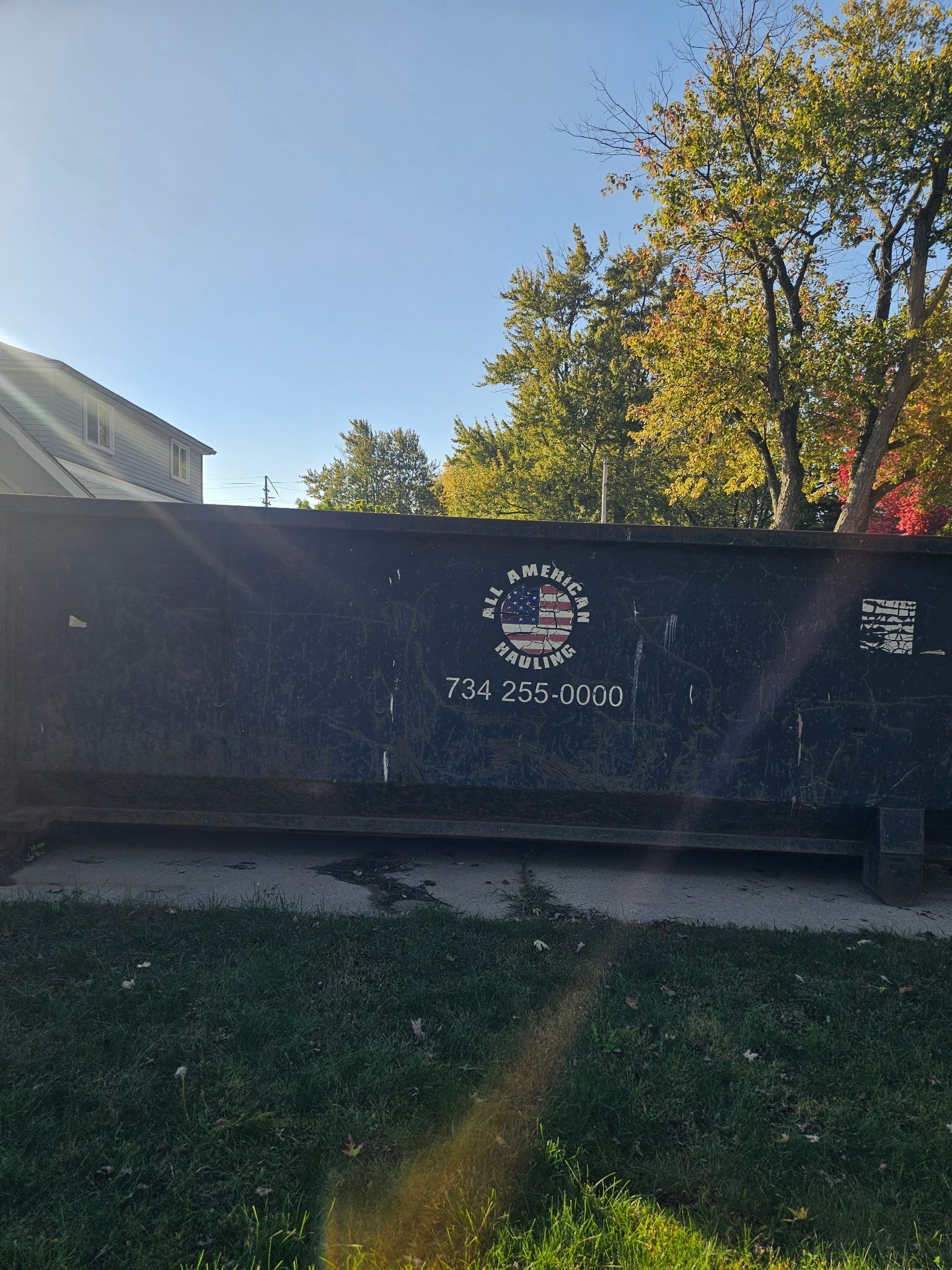 Black Dumpster in Empty Lot