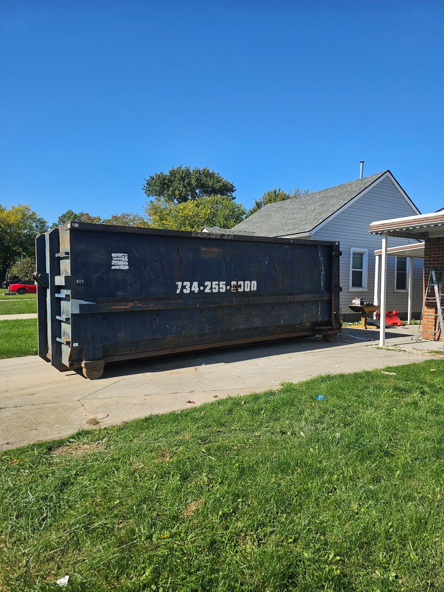 Black Dumpster in Empty Lot