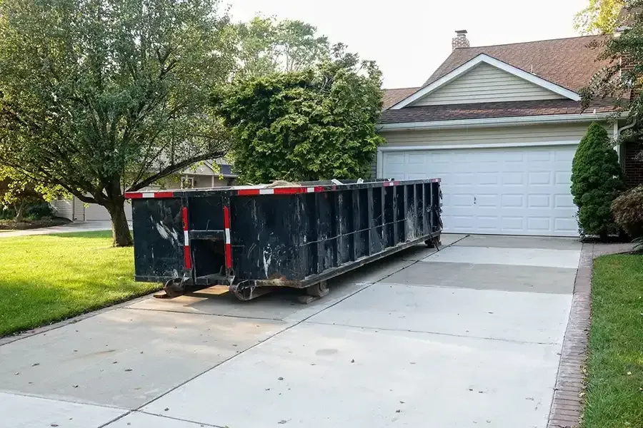 All American Hauling roll-off dumpster delivered to a residential driveway in Taylor, Michigan