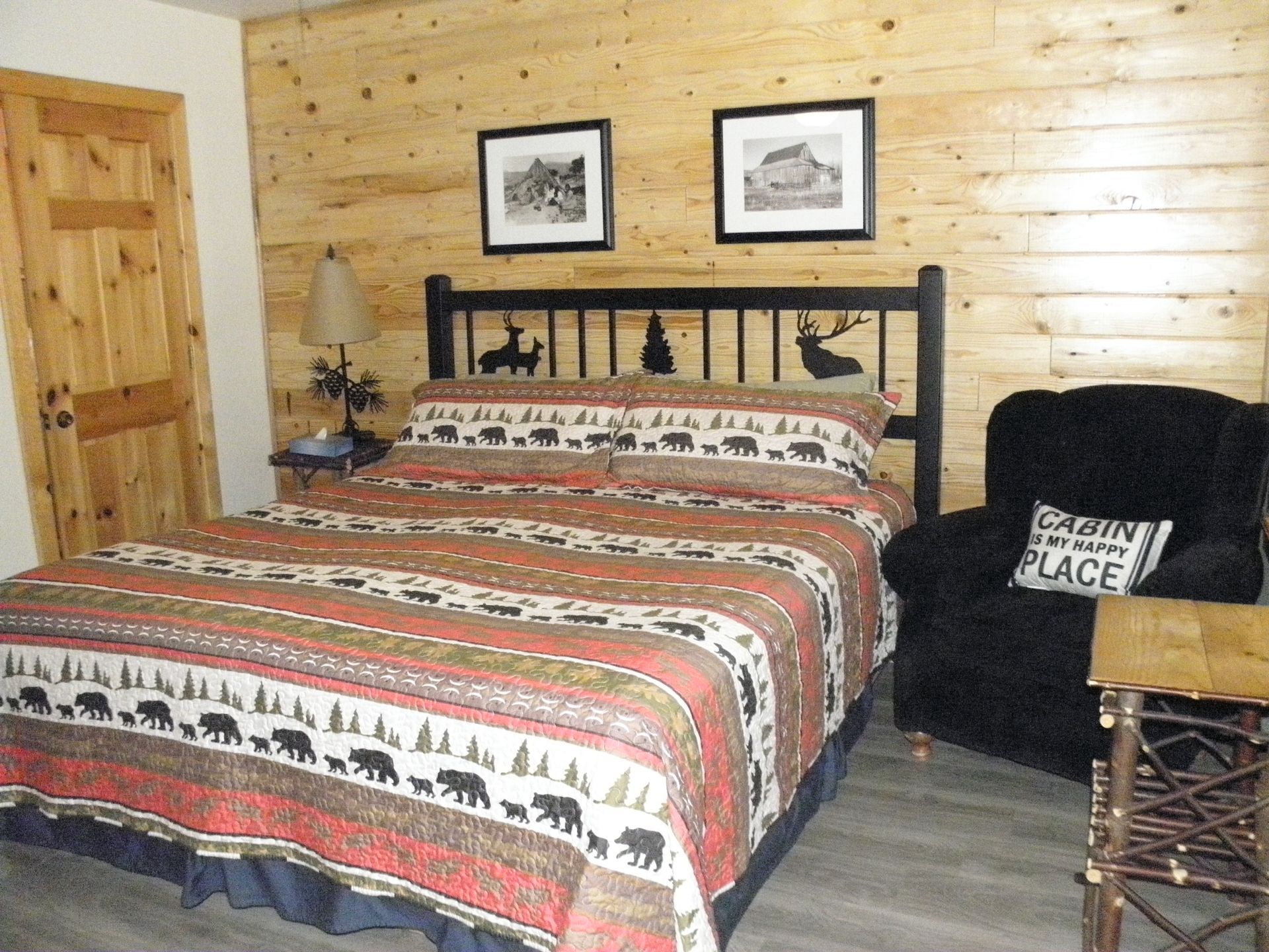 A bedroom with a king size bed and a chair
