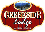 A red sign that says creekside lodge quality lodging
