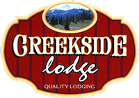 A red sign that says creekside lodge quality lodging