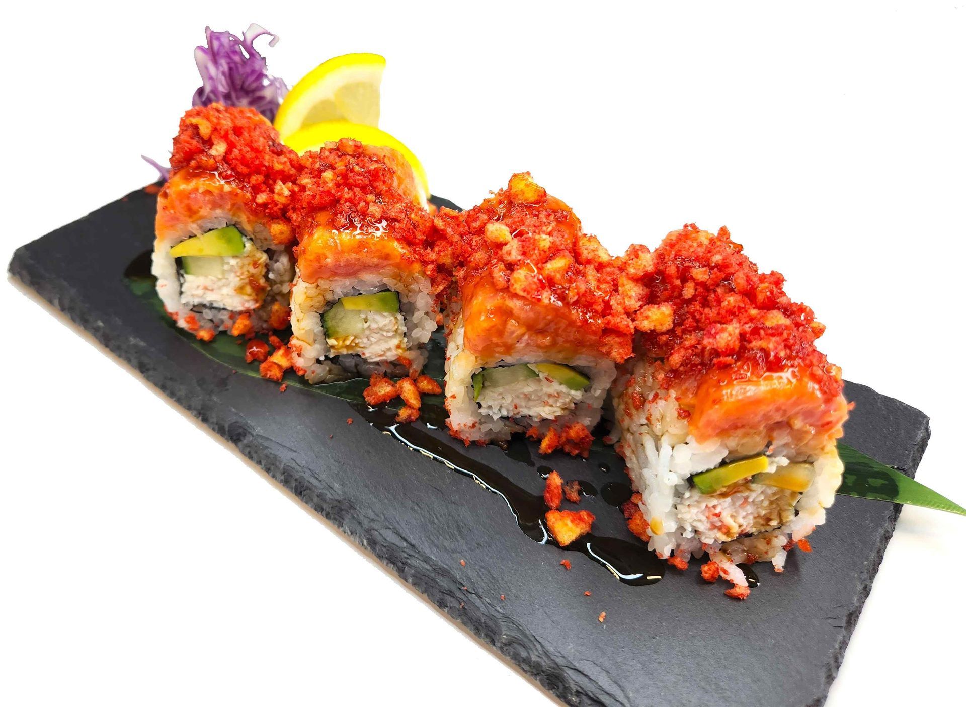 A row of sushi rolls covered in red sauce on a black plate.