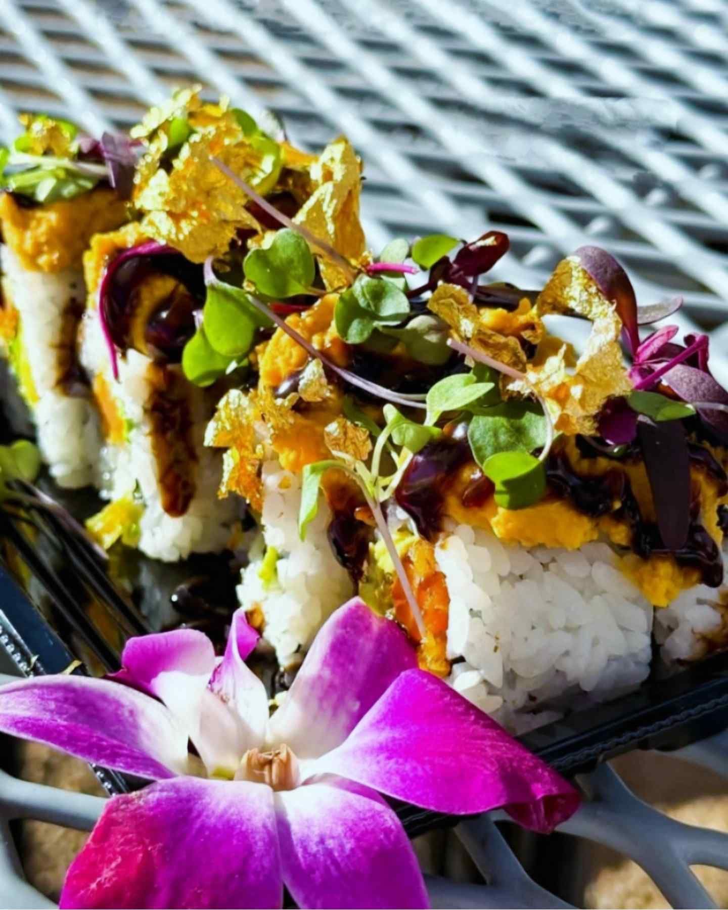 A plate of food with a purple flower on it