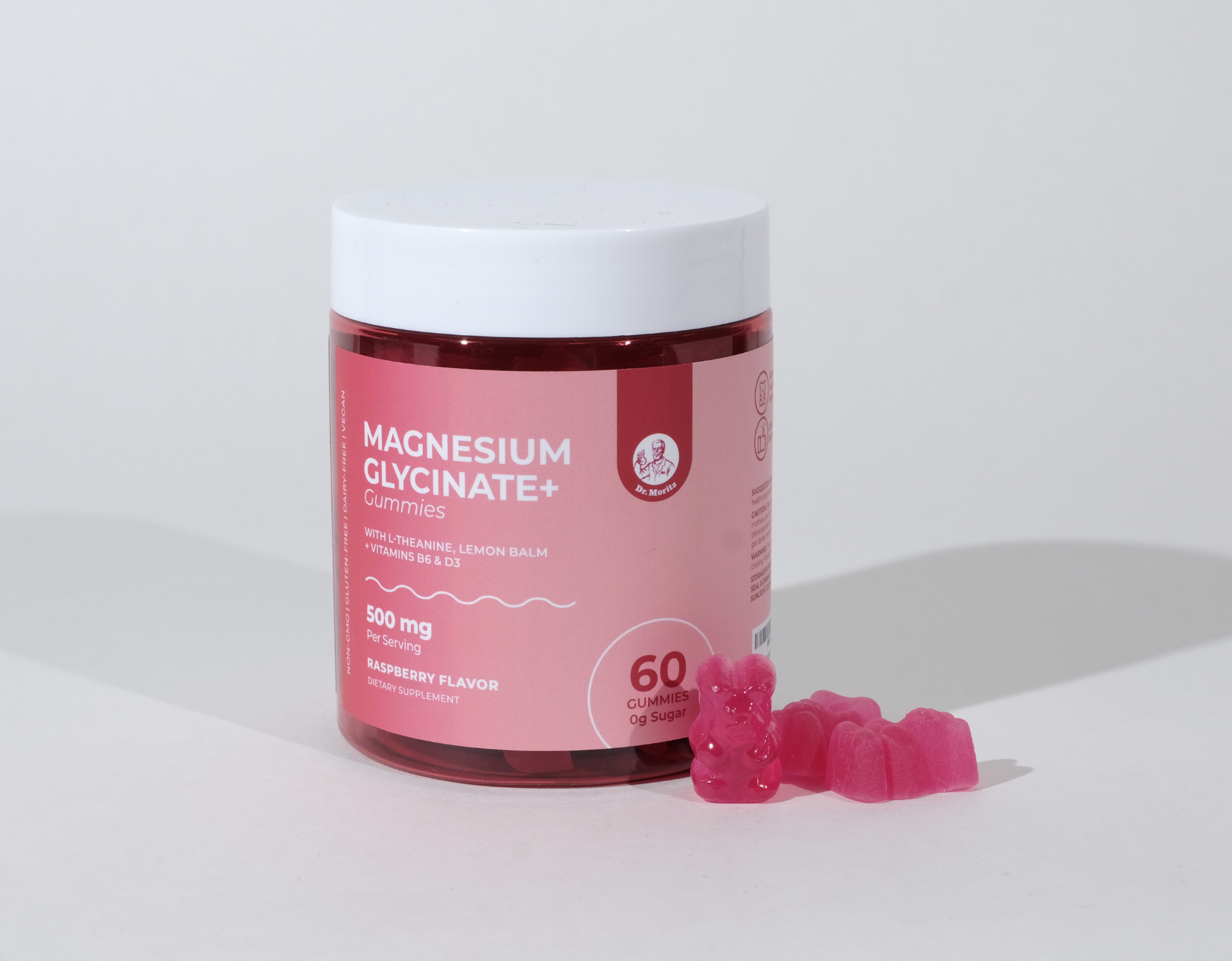 Bottle of Magnesium Glycinate+ gummies, with spilled pink gummies.