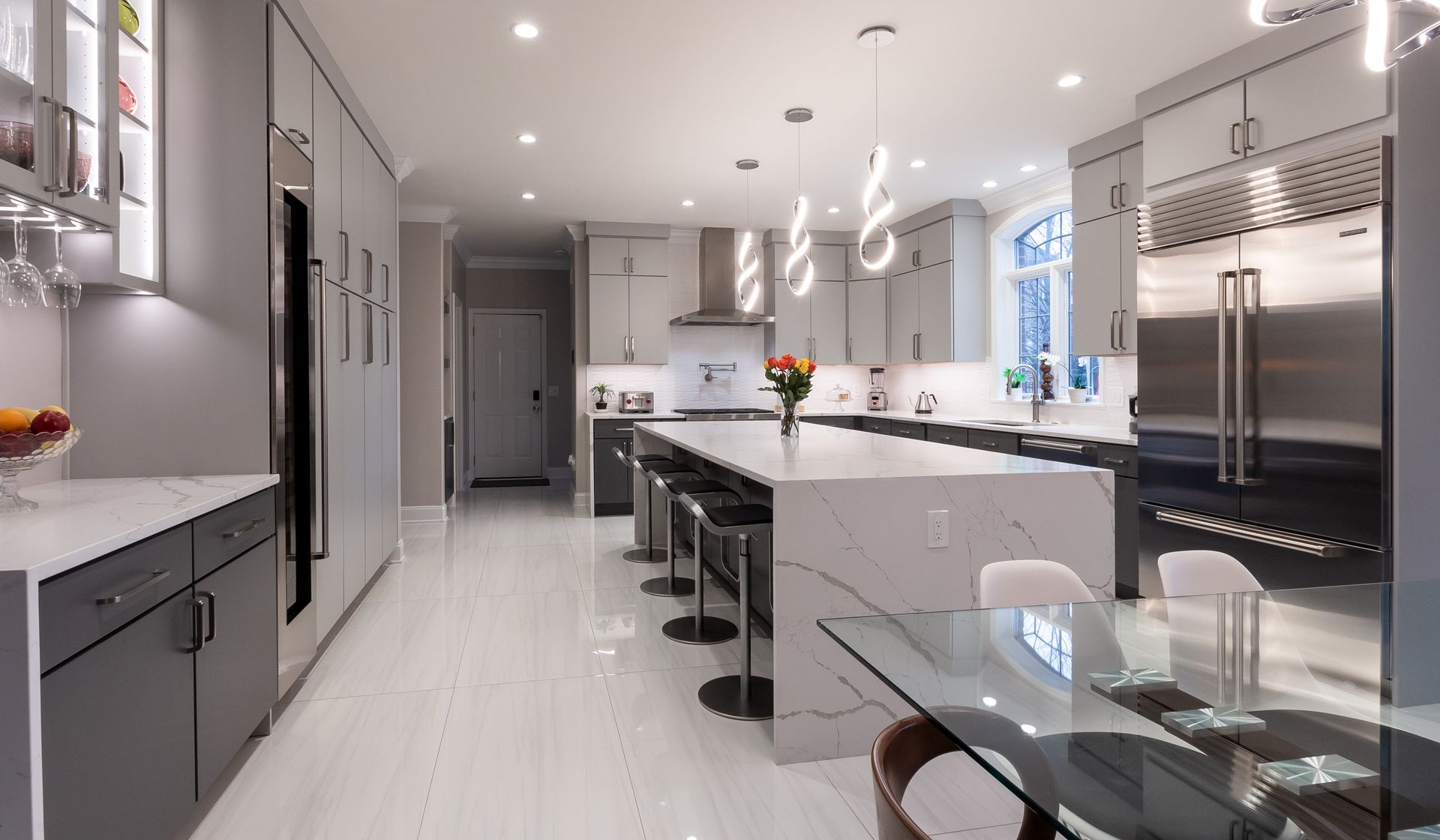 A kitchen with stainless steel appliances and a glass table
