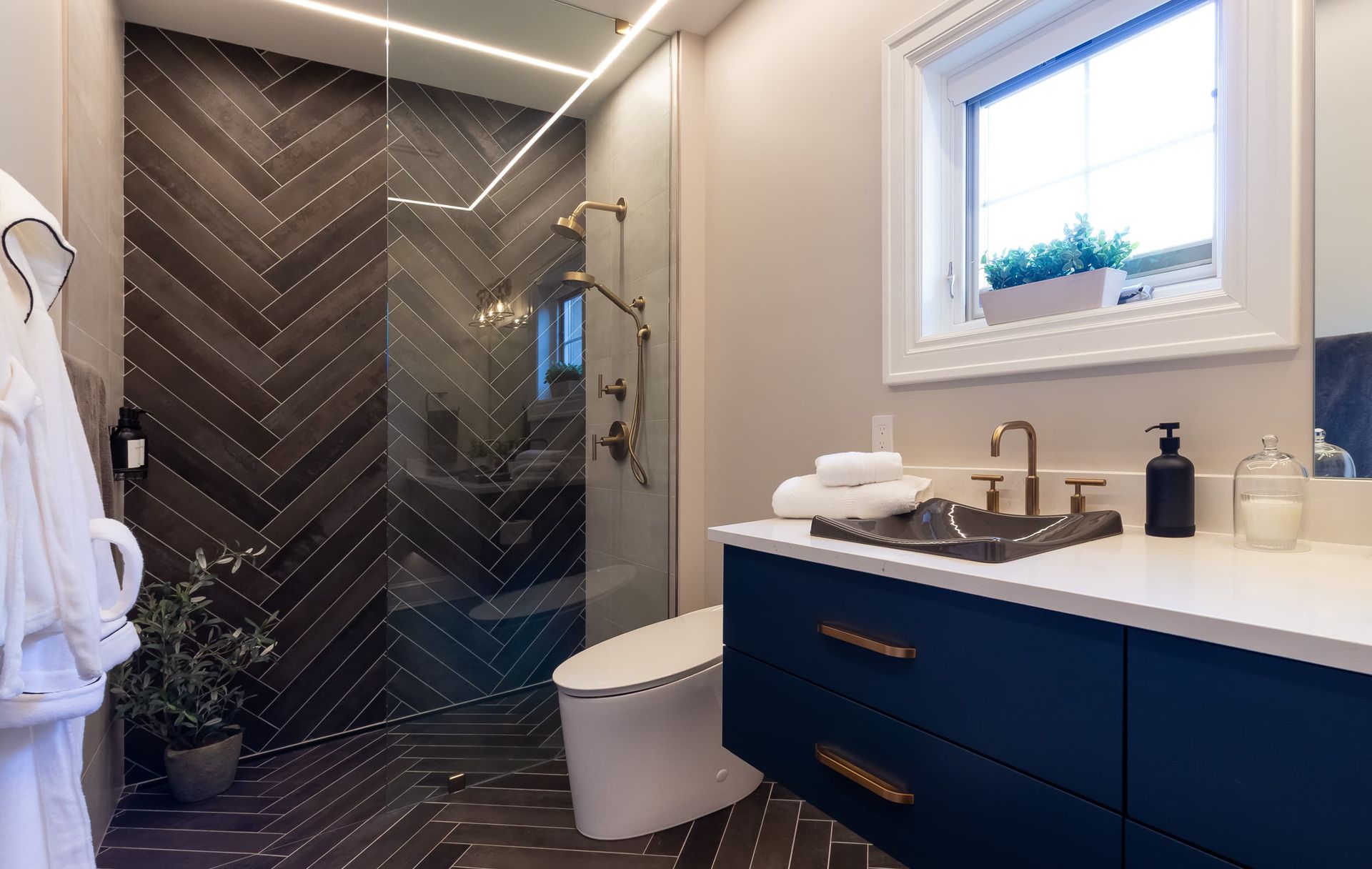 A bathroom with a toilet , sink , and walk in shower.