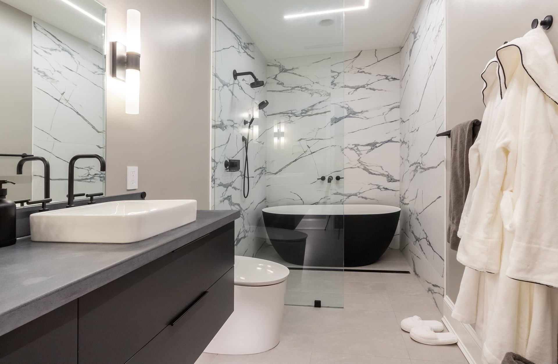 A bathroom with a sink , toilet , tub and shower.