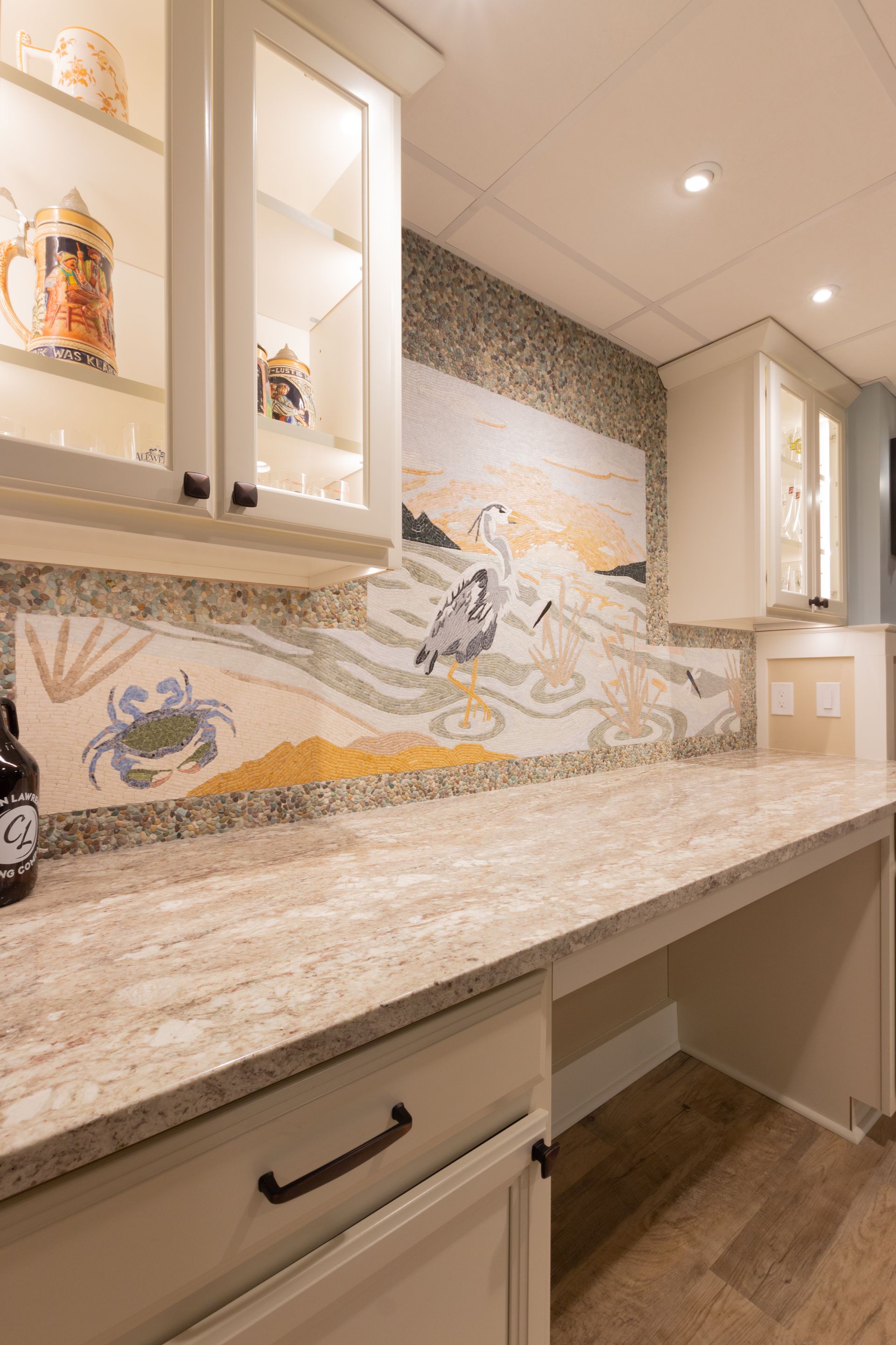 A kitchen with a large counter top and a painting on the wall.