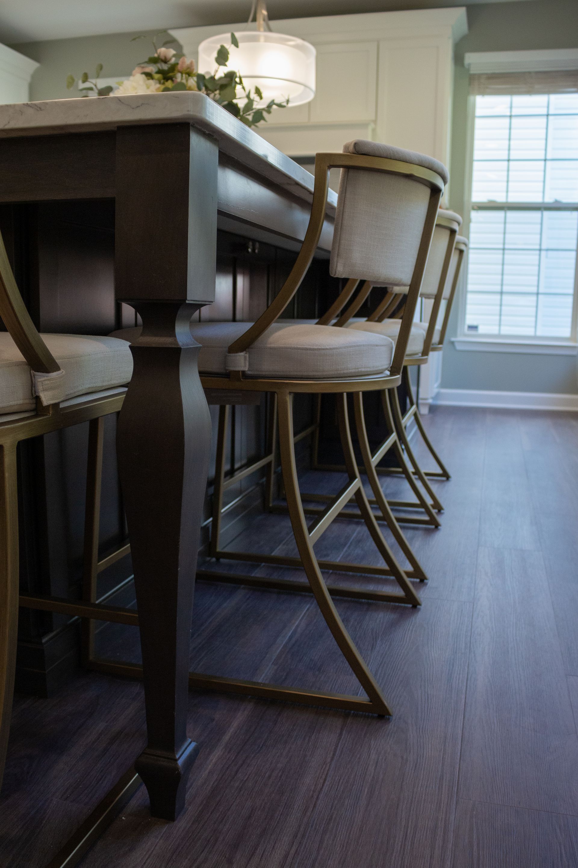 A dining room with a table and chairs and a window