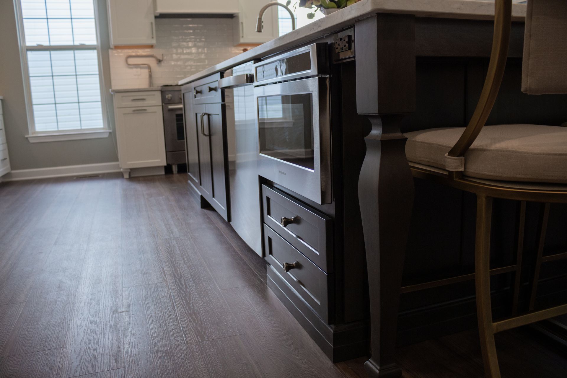 A kitchen with hardwood floors and stainless steel appliances
