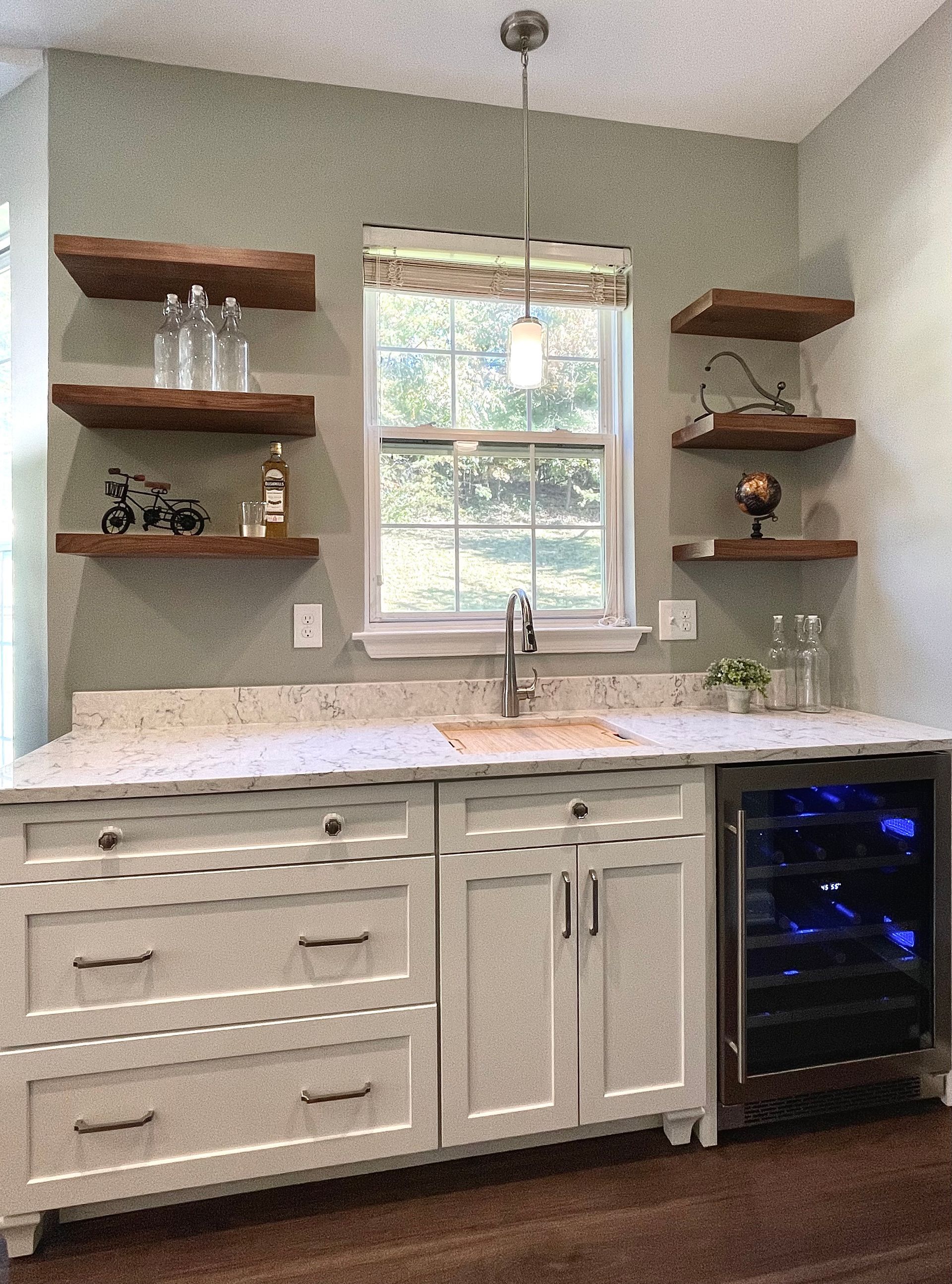 A kitchen with a sink and a wine cooler