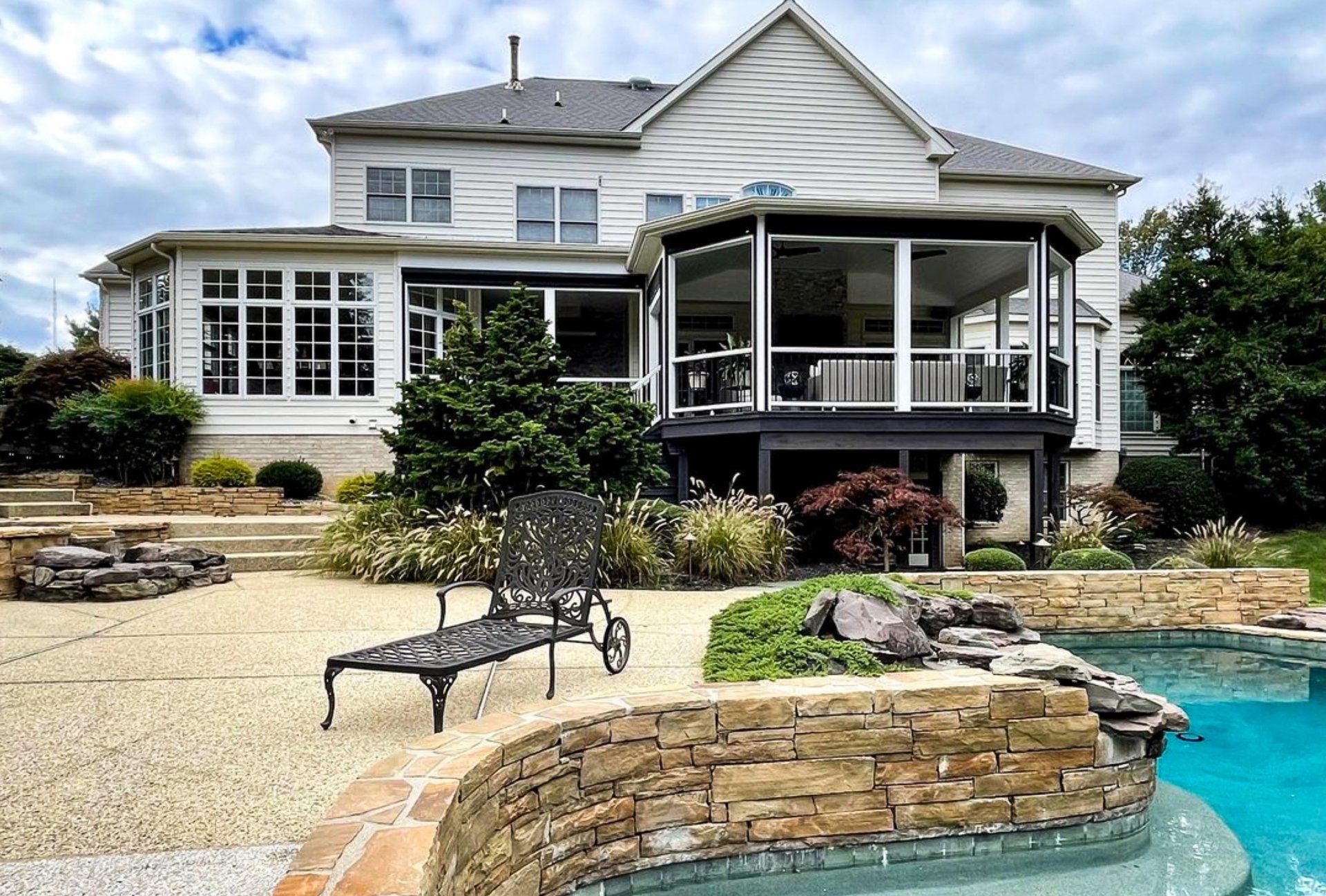 A large house with a swimming pool in front of it