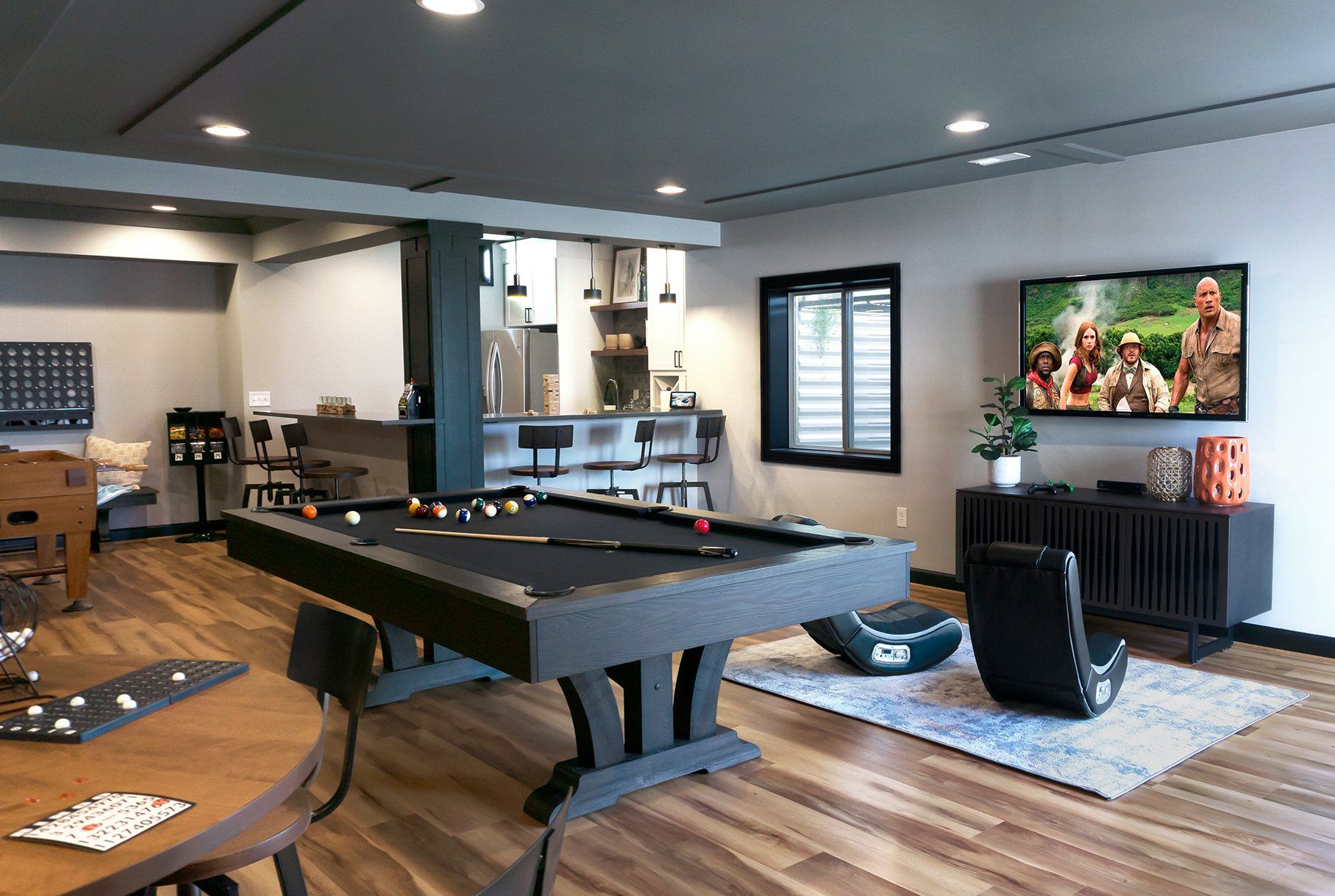 There is a pool table in the middle of the room.