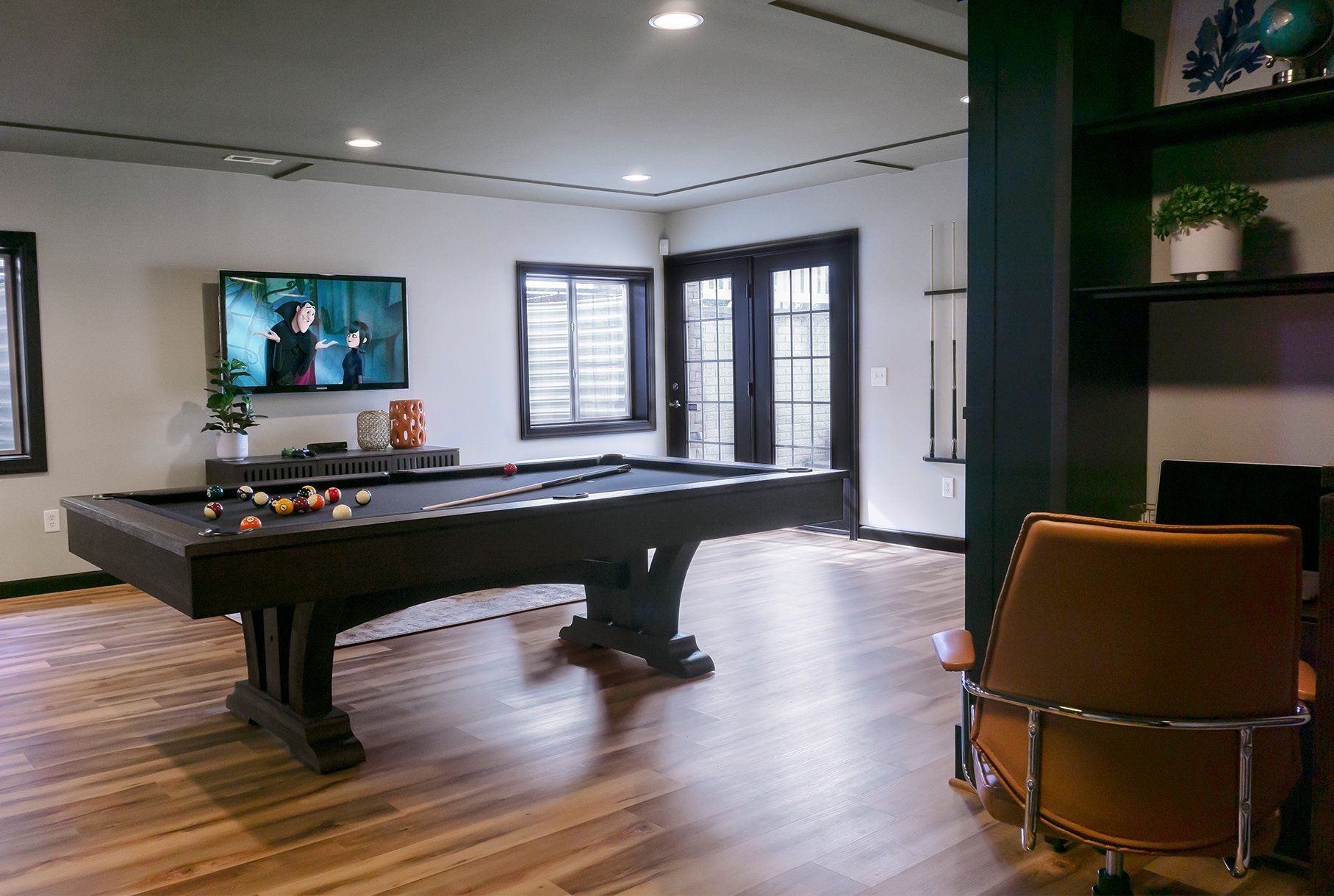 There is a pool table in the middle of the room.